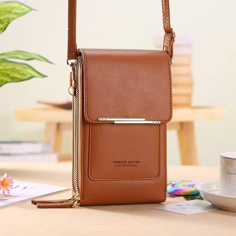 Brown leather crossbody bag on a table with a blurred indoor background