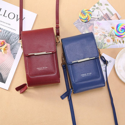 Two small handbags, one red and one blue, on a beige surface with magazines and a lollipop in the background.