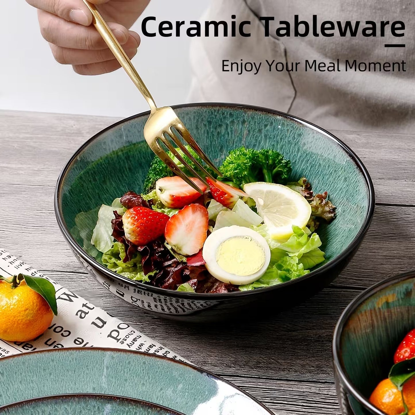 Ceramic tableware with a salad and a fork on a wooden table, promoting 'Enjoy Your Meal Moment'.