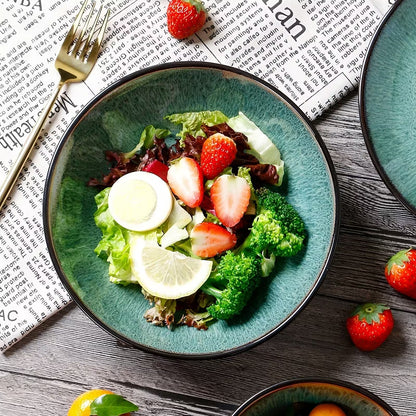 Green salad with strawberries and broccoli on a blue plate, placed on a newspaper.