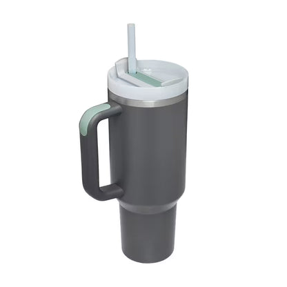 Gray insulated tumbler with handle and straw lid on a white background