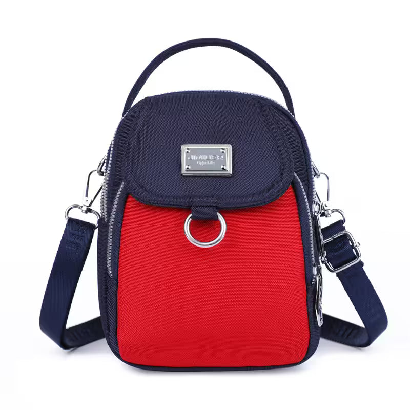 Navy and red crossbody bag with a visible brand label on a white background