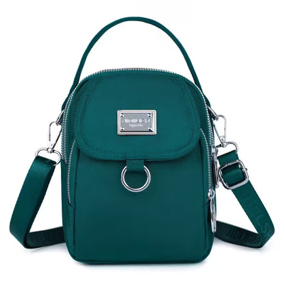 Teal handbag with silver accents on a white background