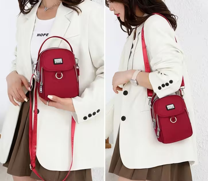 Person wearing a white coat with a red backpack, holding it in front of a white background.