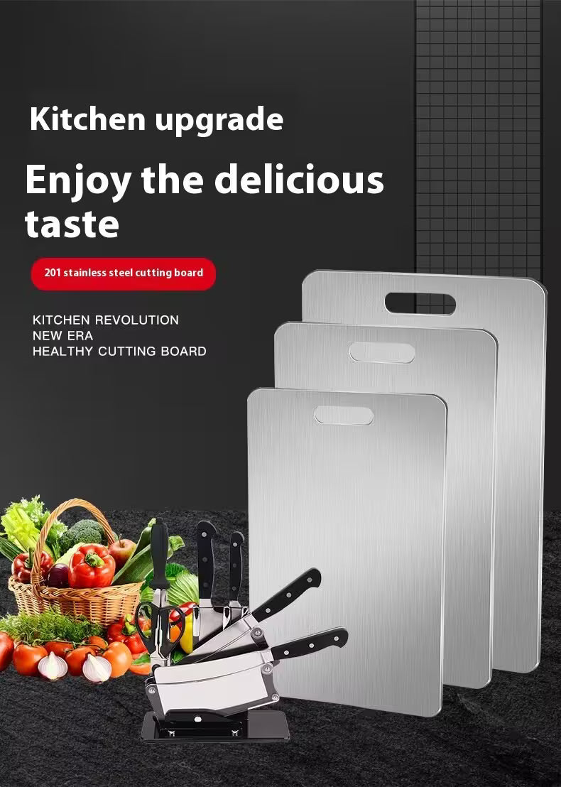 Stainless steel cutting boards with kitchen utensils and vegetables on a dark background