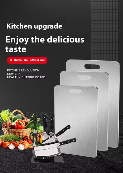 Stainless steel cutting boards with kitchen utensils and vegetables on a dark background