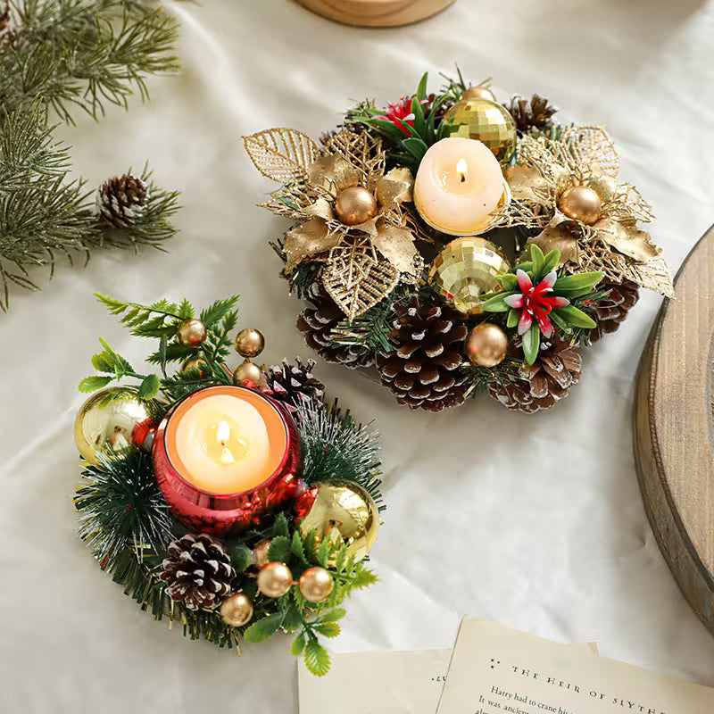 Decorative candle holders with greenery and pinecones on a light surface