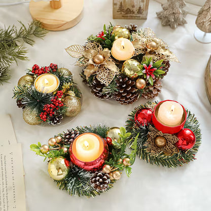Decorative candle holders with greenery, pinecones, and candles on a white surface.