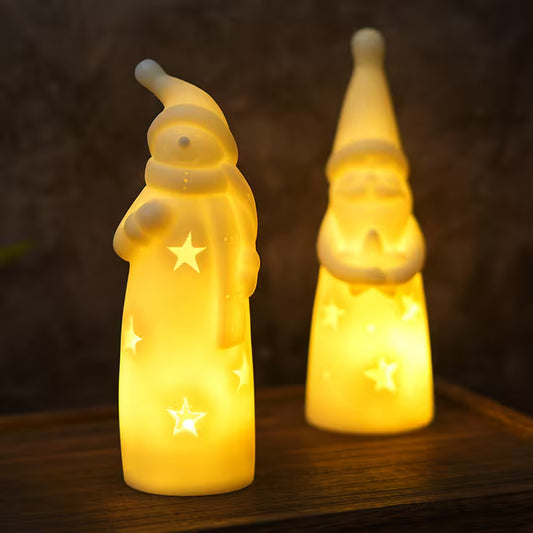 Two glowing Santa Claus figures with star designs on a dark background