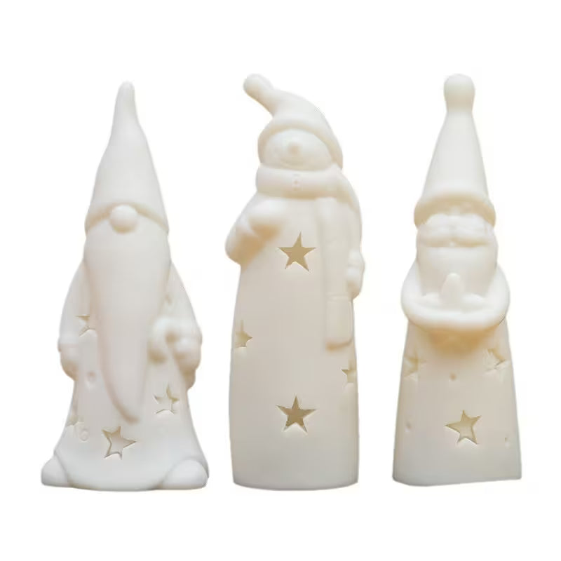 Three white ceramic figures with star designs on a white background