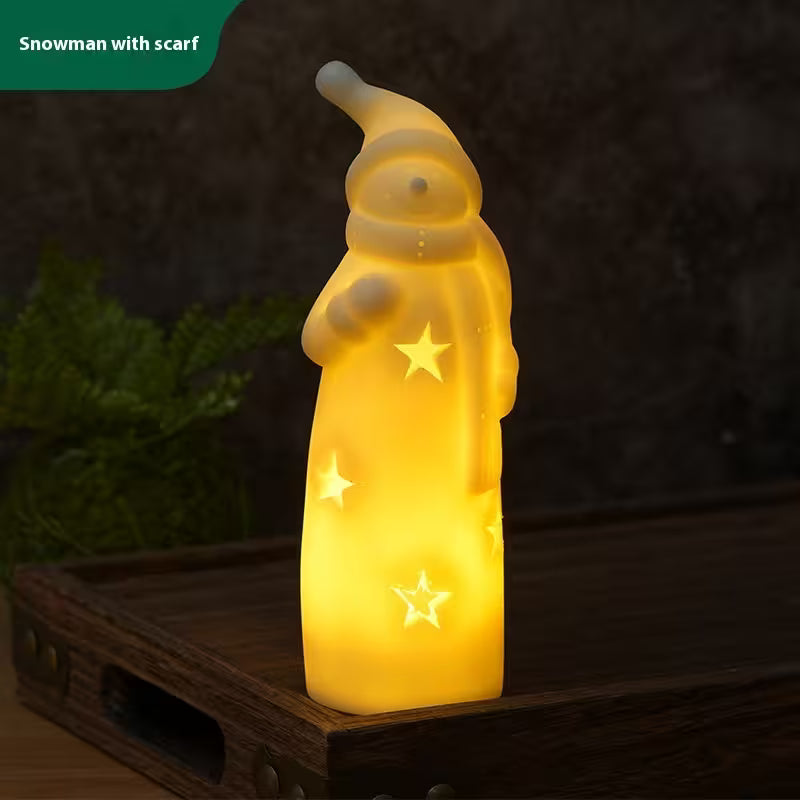 Decorative light shaped like a snowman with stars on a dark background