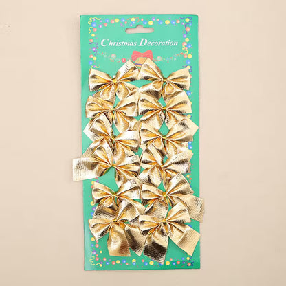 Pack of gold Christmas bows on a green card with decorative elements.
