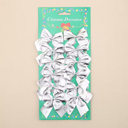 Pack of silver bows on a green card with 'Christmas Decoration' text.