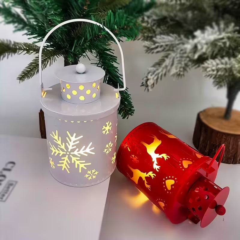Decorative lanterns with snowflake and Christmas tree designs on a surface with a Christmas tree in the background.
