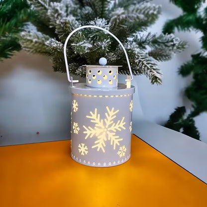Decorative lantern with snowflake patterns on a reflective surface with a blurred green background