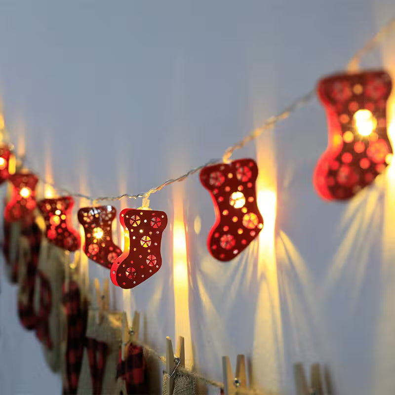 Decorative string lights shaped like red stockings with a blurred background