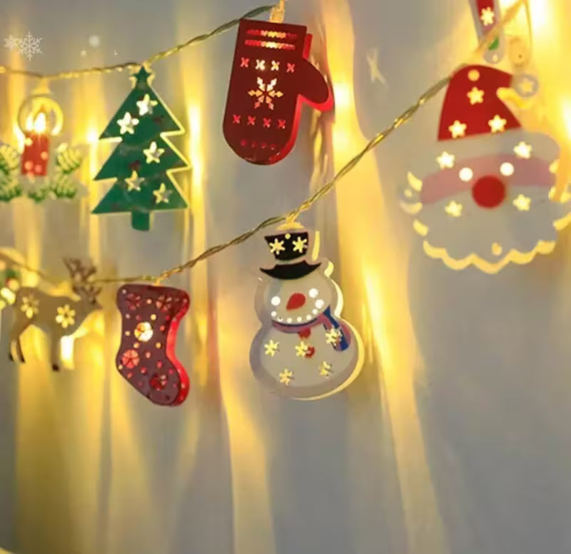 String lights with Christmas-themed decorations on a white background