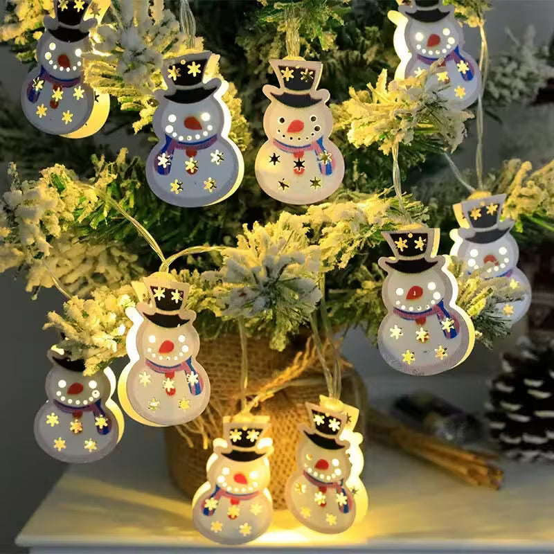 Decorative snowman lights hanging on a Christmas tree.