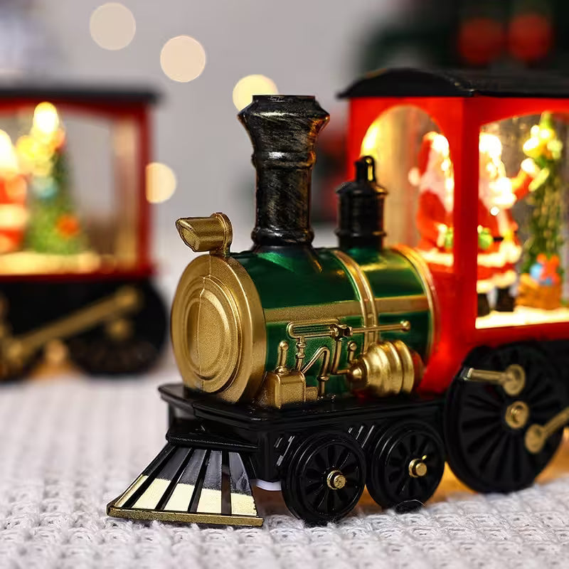 Toy train with a green engine and red carriages on a textured surface.