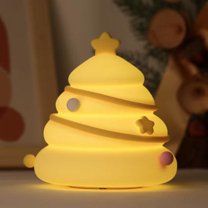 Yellow night light shaped like a Christmas tree with stars and balls on a blurred background