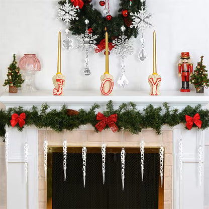 Decorative Christmas mantel with garland, candles, and ornaments.