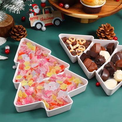 White Christmas tree-shaped bowls filled with colorful candies on a festive background.