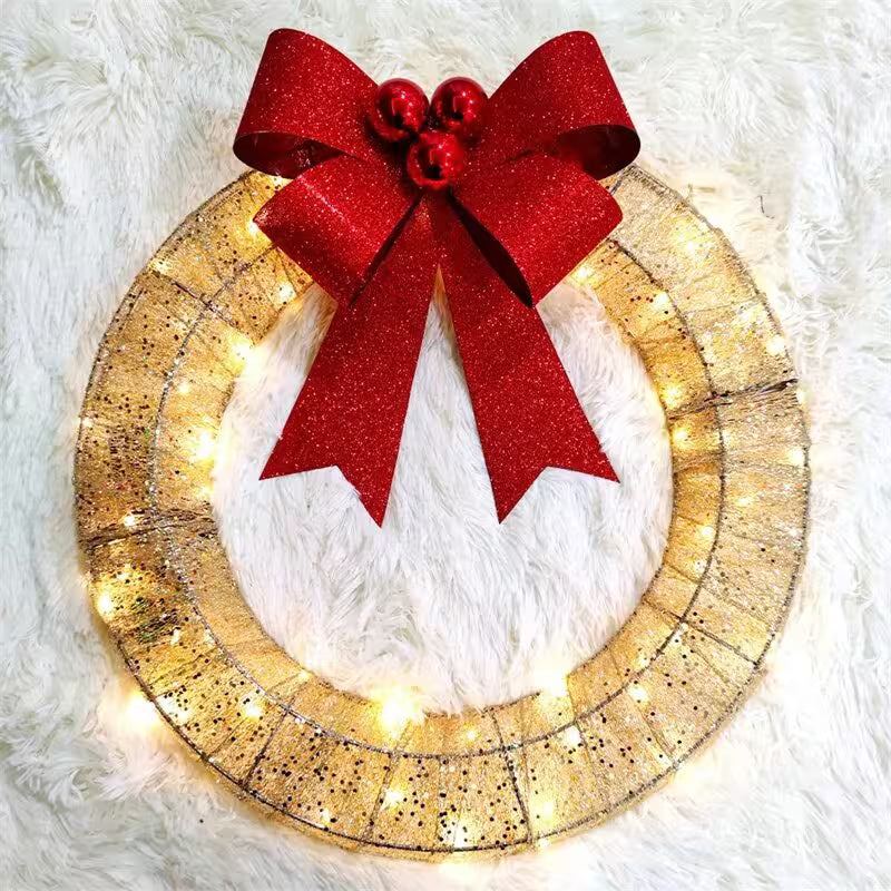 Decorative wreath with a red bow and lights on a white fluffy background