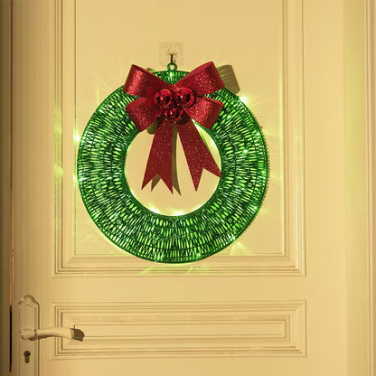 Green Christmas wreath with a red bow on a door