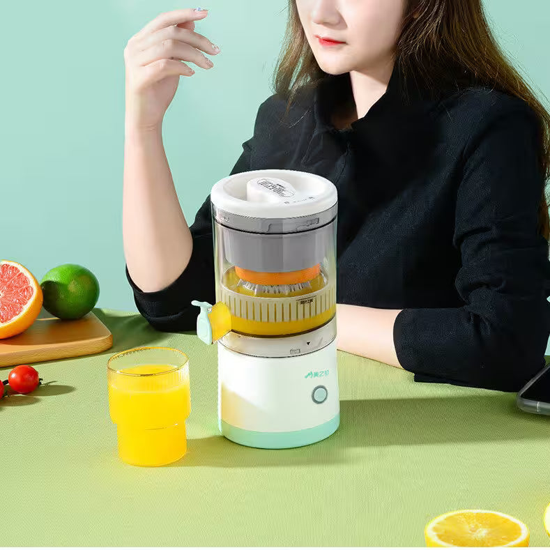 Person using a portable juicer with a glass of orange juice on a green background