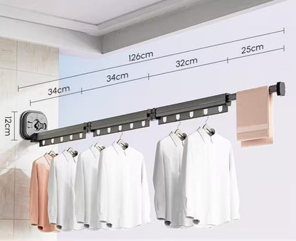 Clothing rack with clothes and measurements on a white wall