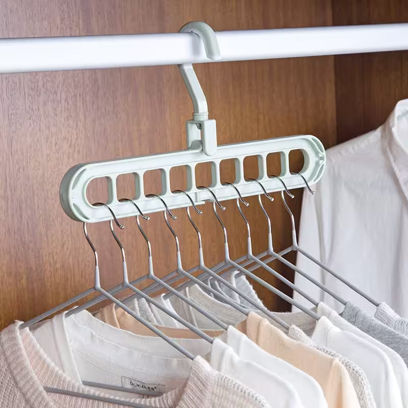 Multi-layered hanger with clothes on a wooden background
