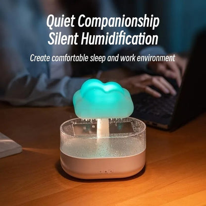 Humidifier with cloud design on a desk, person using laptop in background