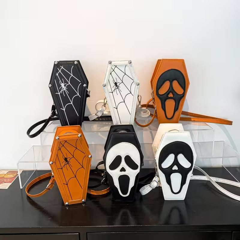 Halloween-themed keychains and pouches on a clear stand with a white background