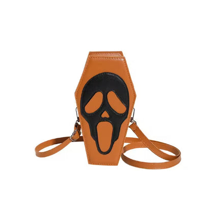 Brown coffin-shaped bag with black face design on a white background