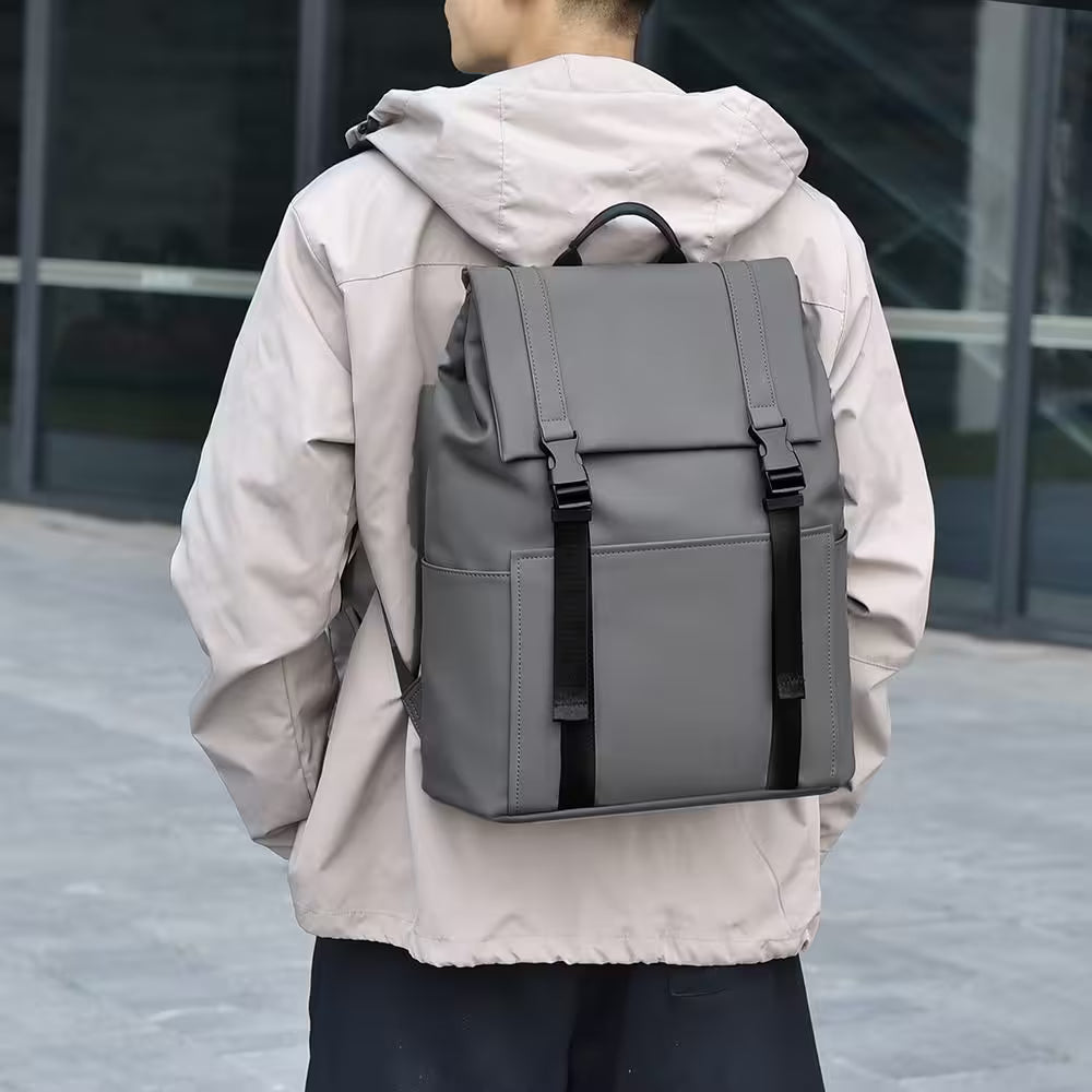 Person wearing a gray backpack with a blurred background