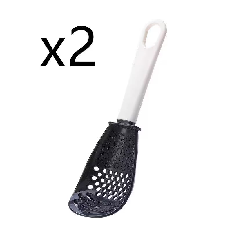 Black perforated spoon with white handle on a white background, labeled 'x2'.
