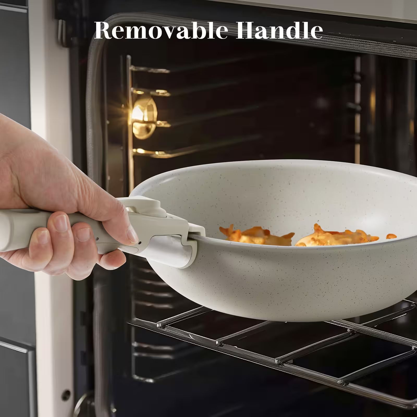 Person using a wok with a removable handle to cook food in an oven.