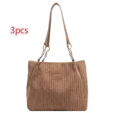 Brown textured handbag with a strap on a white background