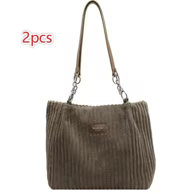 Brown ribbed handbag with a visible brand label on a white background