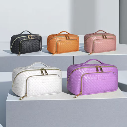 Five quilted travel bags in black, orange, pink, white, and purple on a light gray background.