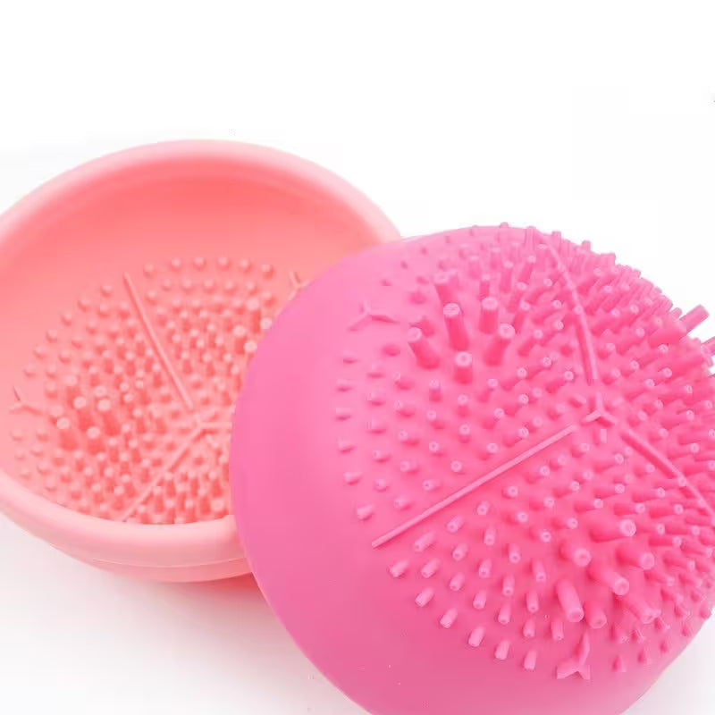 Pink silicone scrubber with textured surface on a white background