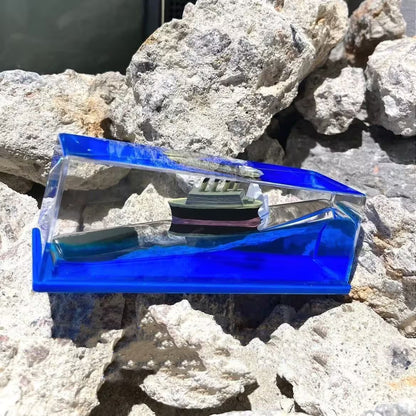 Blue and clear plastic case on a rocky surface