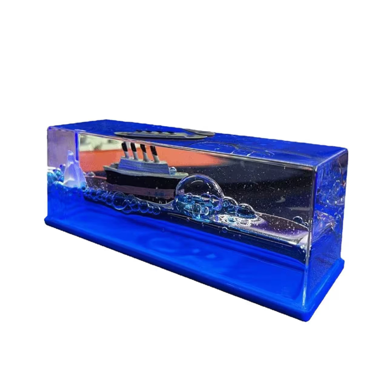 Model ship in a blue display case on a white background