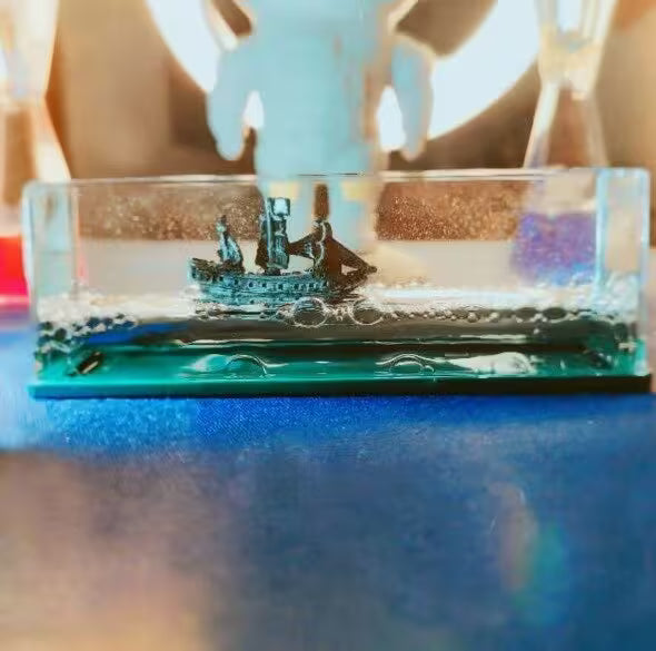 Decorative model of a ship in a glass container on a blurred background