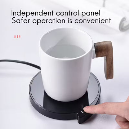 White mug with wooden handle on a black heating pad, with text 'Independent control panel Safer operation is convenient'.