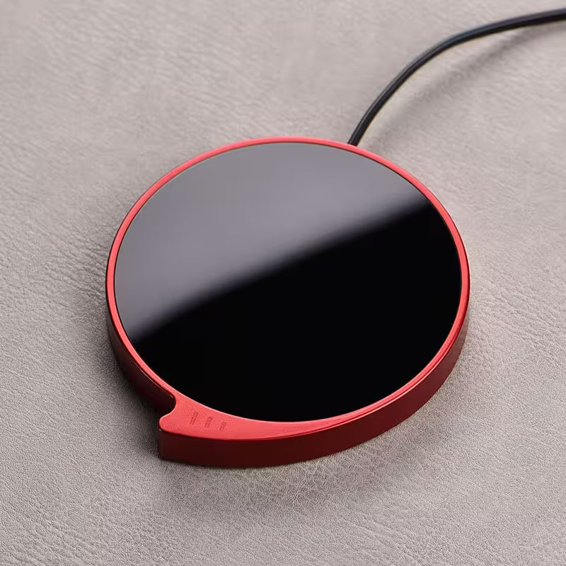 Red and black circular device on a gray surface