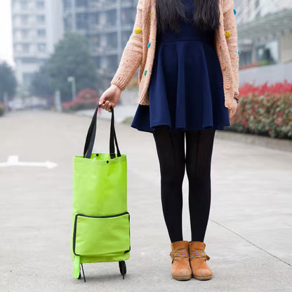 Person holding a bright green shopping bag on a city street