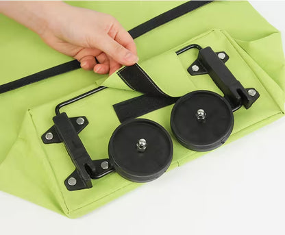 Green bag with black wheels and a hand interacting with it on a white background