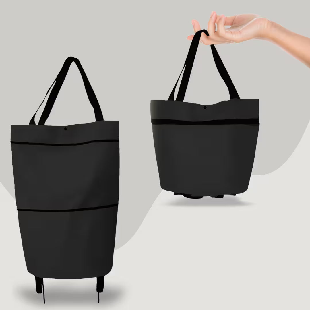Black tote bag with a hand holding it against a gray background