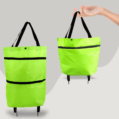 Green folding shopping bag with black straps on a gray background